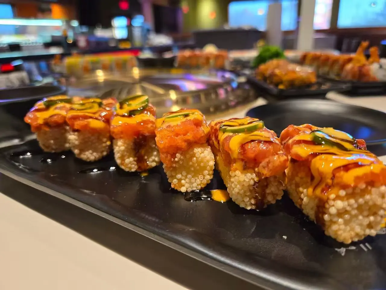 Crispy rice sushi roll with spicy tuna, jalapeño, and dual sauces at Daruma BBQ & Sushi AYCE, a Asian Restaurant in Holyoke